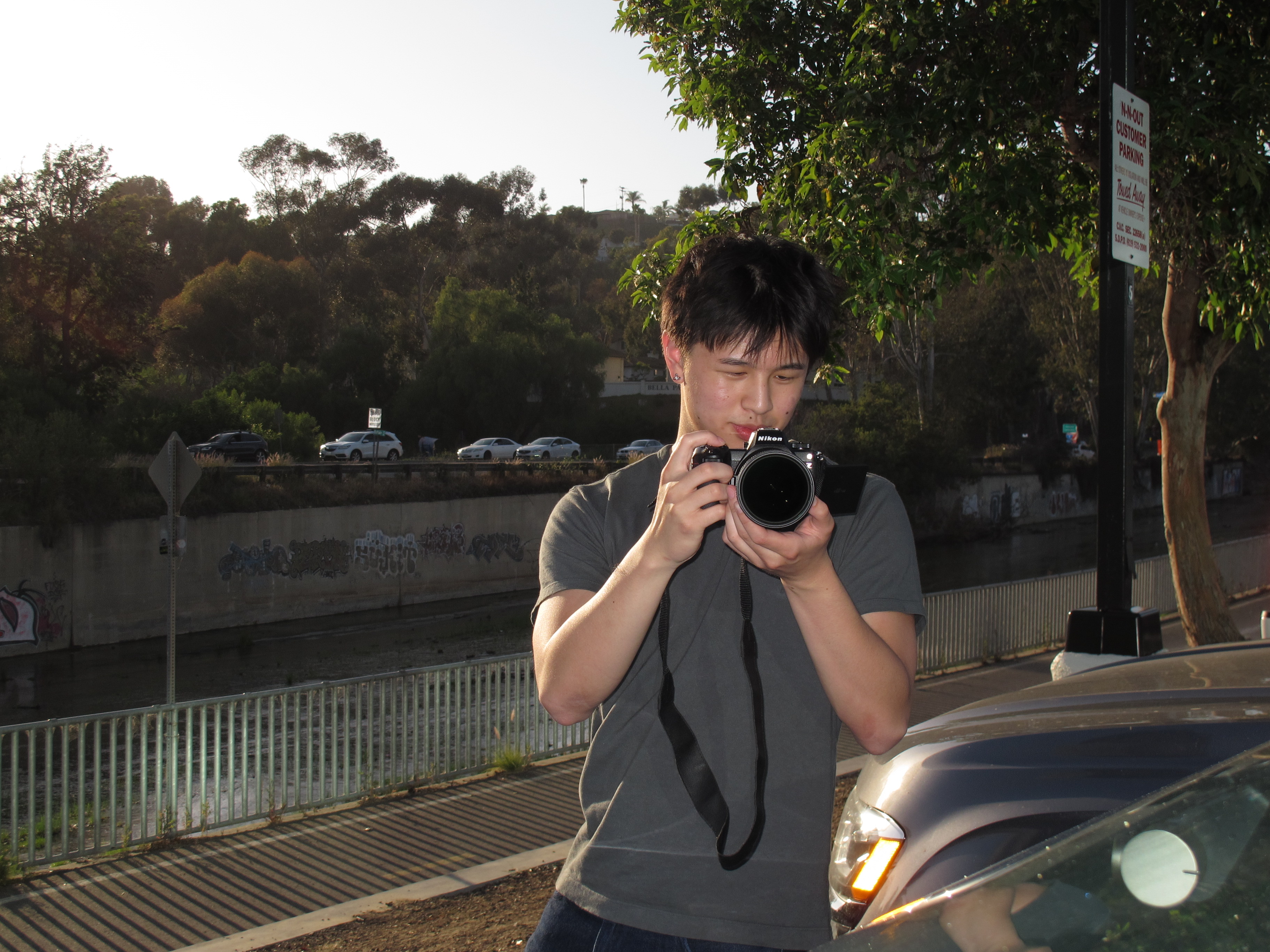 Max Shen photographing by a canal